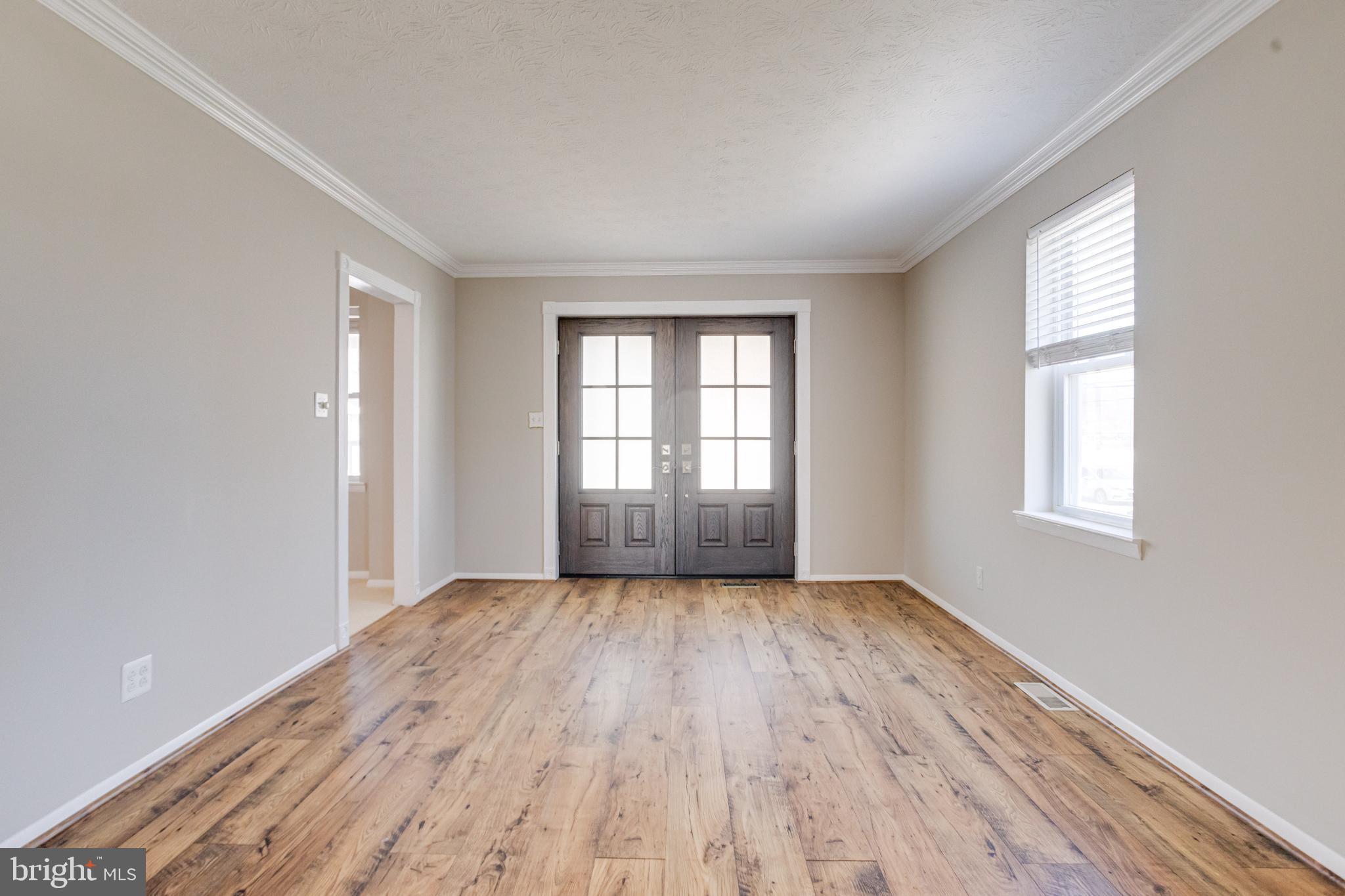 3809 Clarks Point Road Middle River, MD 21220 - Photo 7 of 49 an empty room with wooden floor and windows