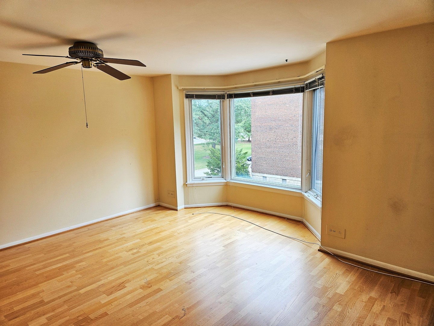 500 Thames Parkway, Unit 2K Park Ridge, IL 60068 - Photo 17 of 18 a view of an empty room with a window and wooden floor