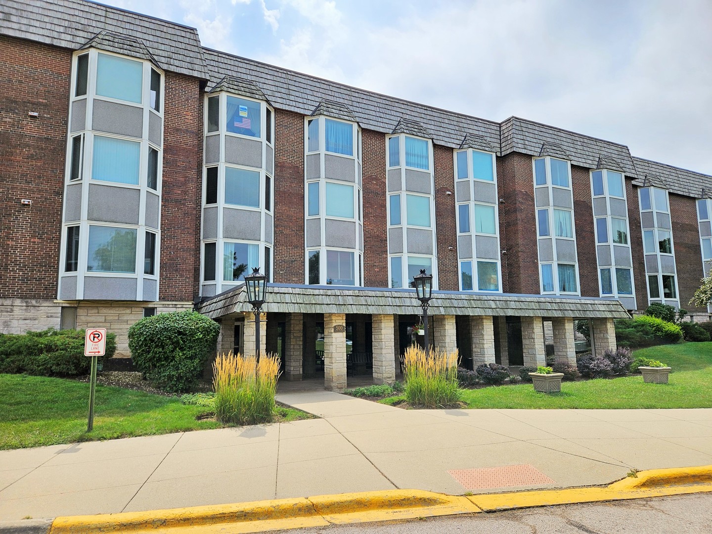 500 Thames Parkway, Unit 2K Park Ridge, IL 60068 - Photo 2 of 18 a front view of residential houses with yard