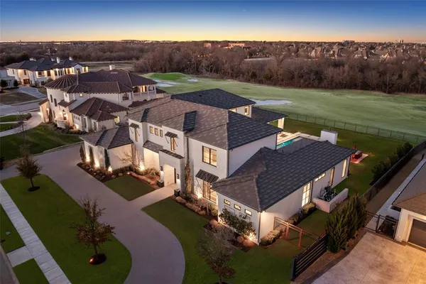 an aerial view of a house with garden space and street view