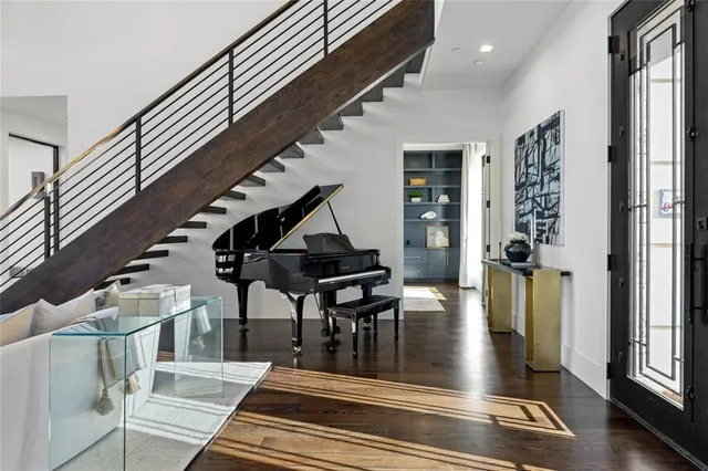 a view of entryway and hall with wooden floor