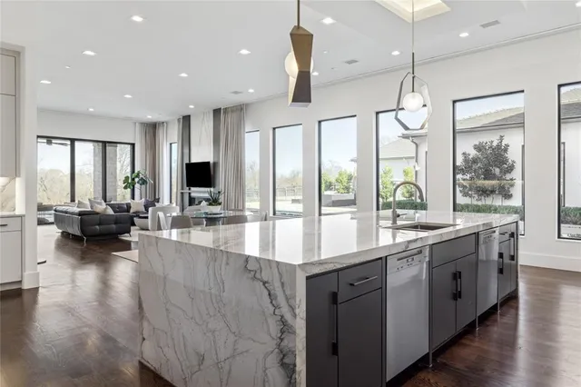 a large kitchen with a large window and stainless steel appliances