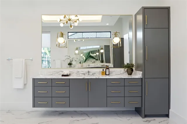 a bathroom with a granite countertop sink vanity and a mirror