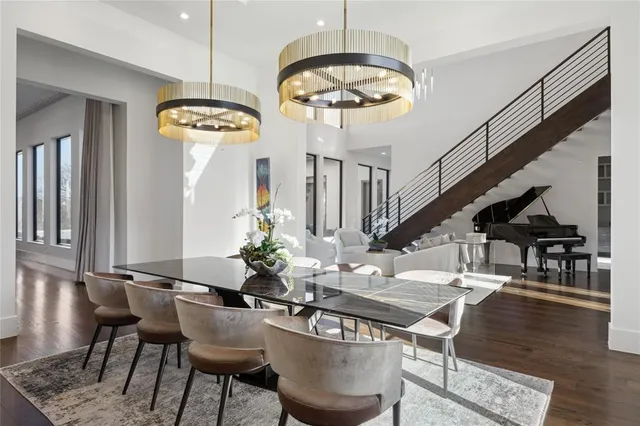 a view of a dining room with furniture a chandelier and wooden floor