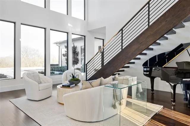 a living room with furniture and a floor to ceiling window