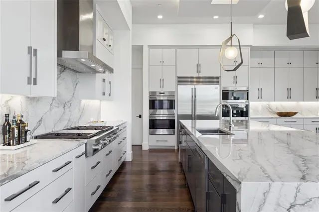 a kitchen with stainless steel appliances granite countertop a stove oven and a sink with granite countertops