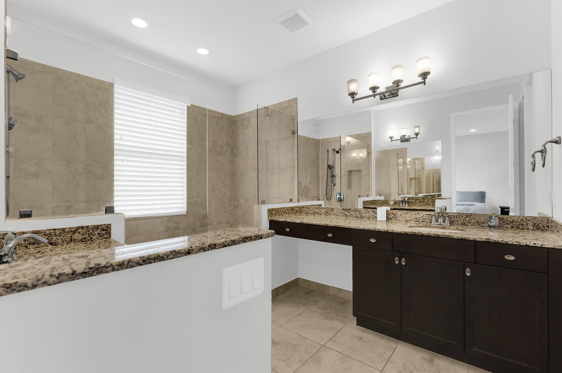 6640 Quiet Wave Trail, Unit 67 Boca Raton, FL 33433 - Photo 16 of 35 a large bathroom with a granite countertop sink a large mirror and a bathtub