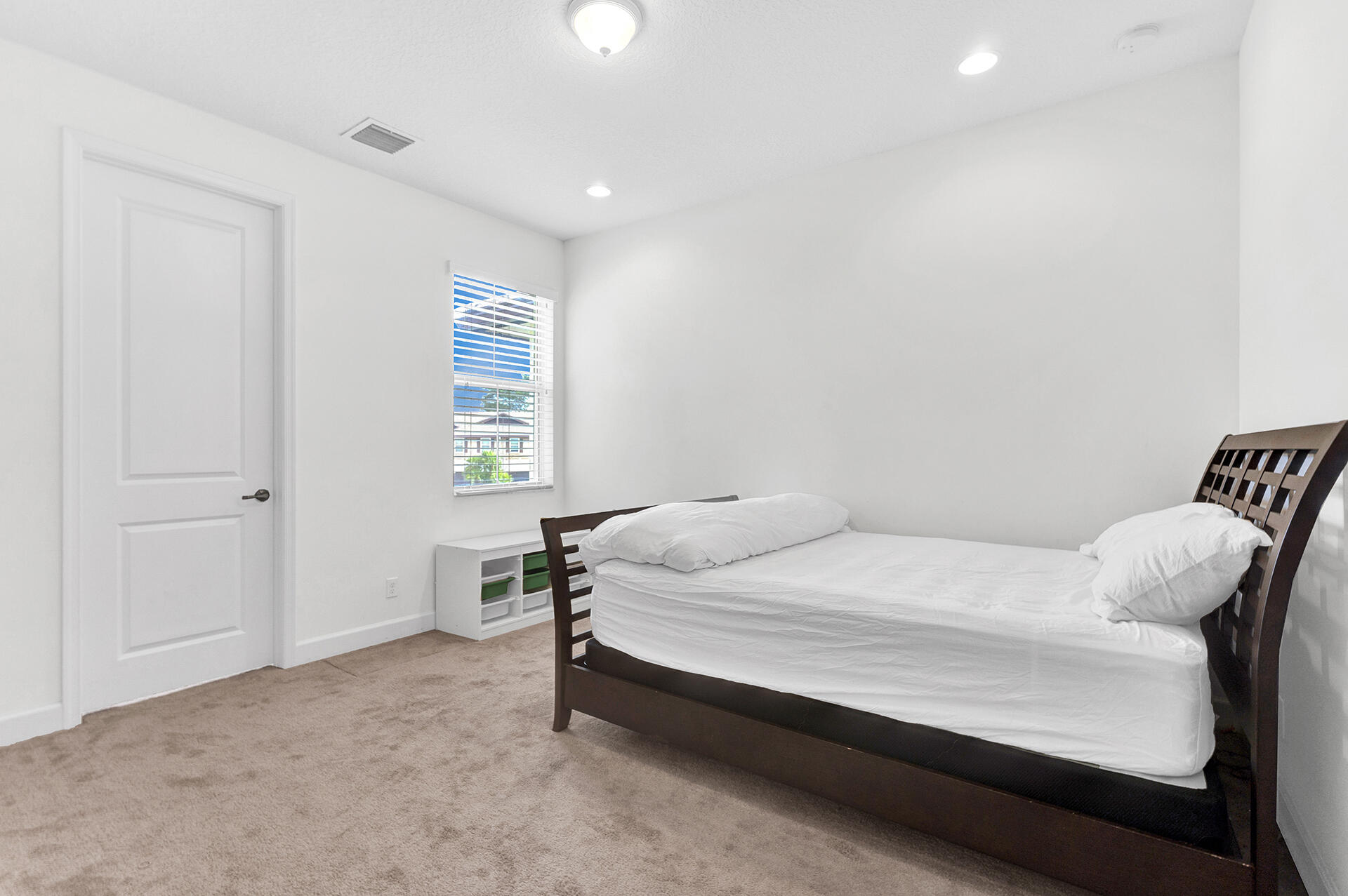 6640 Quiet Wave Trail, Unit 67 Boca Raton, FL 33433 - Photo 20 of 35 a bed sitting in a bedroom next to a window