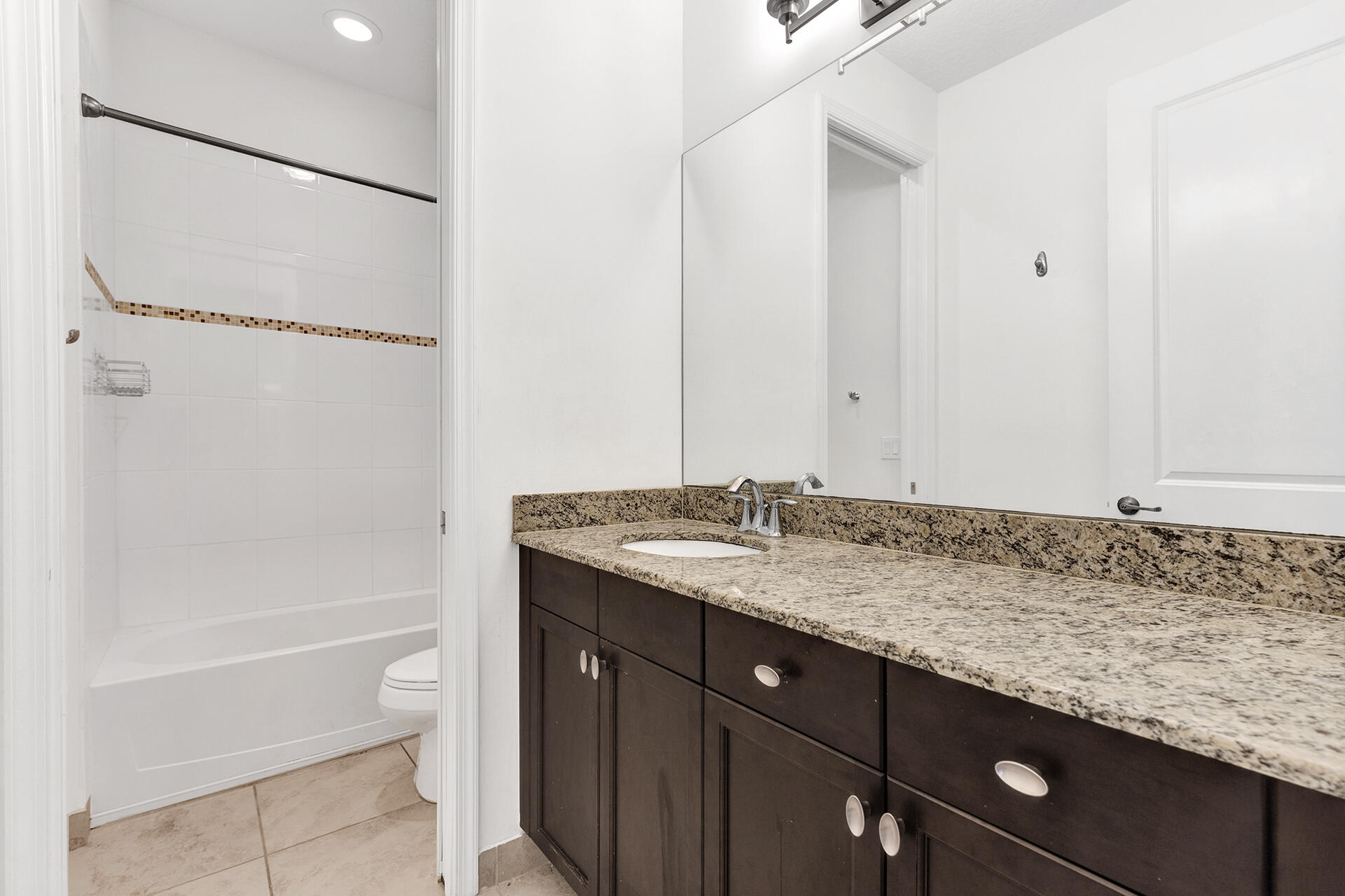 6640 Quiet Wave Trail, Unit 67 Boca Raton, FL 33433 - Photo 22 of 35 a bathroom with a granite countertop sink and a mirror