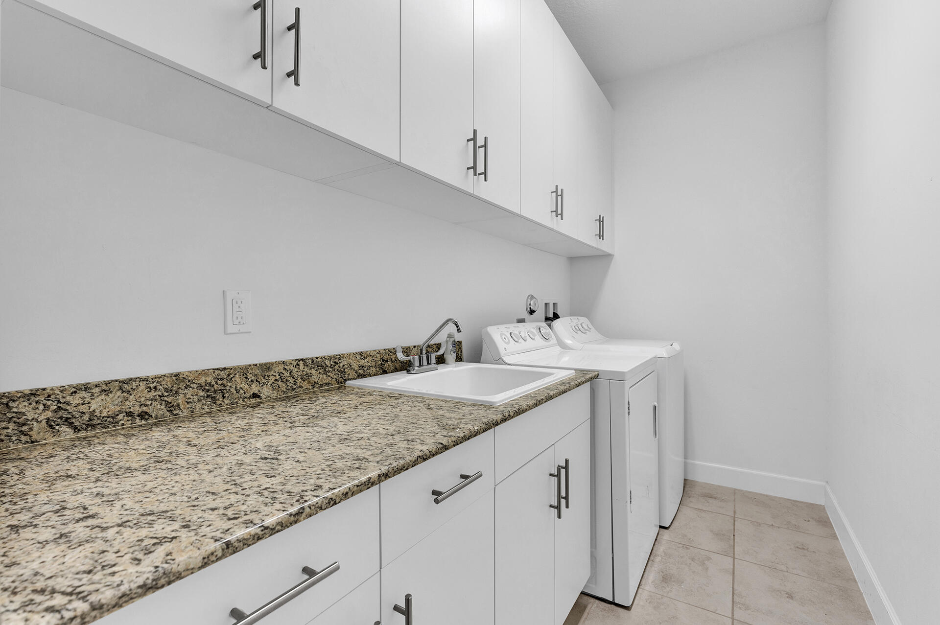 6640 Quiet Wave Trail, Unit 67 Boca Raton, FL 33433 - Photo 23 of 35 a bathroom with a granite countertop sink and cabinets