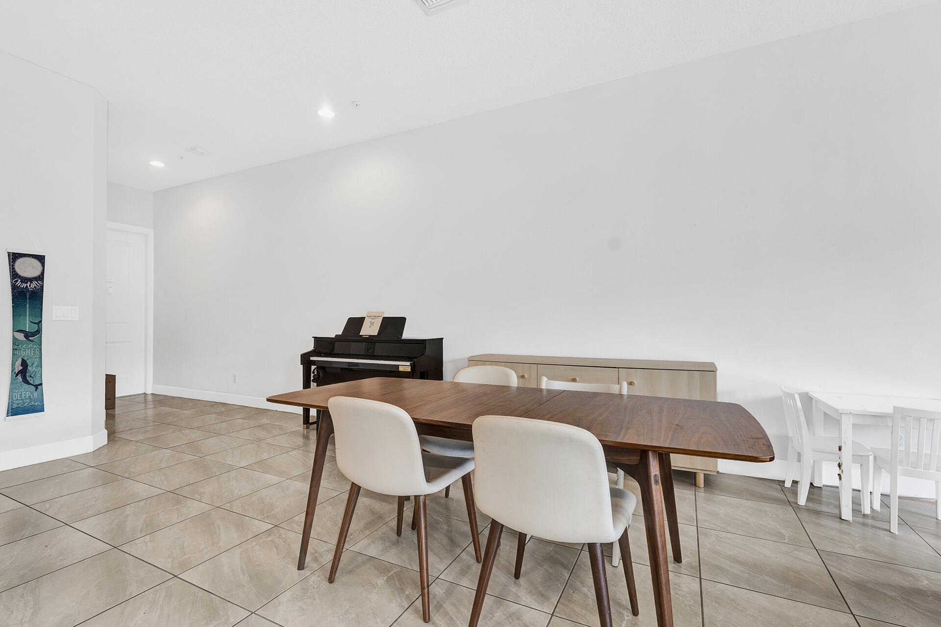 6640 Quiet Wave Trail, Unit 67 Boca Raton, FL 33433 - Photo 10 of 35 a view of a dining room with furniture and wooden floor