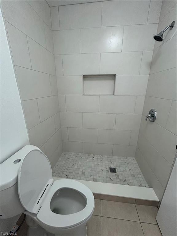 1989 Rookery Bay Drive, Unit 704 Naples, FL 34114 - Photo 9 of 10 Bathroom with a stall shower and light tile patterned floors