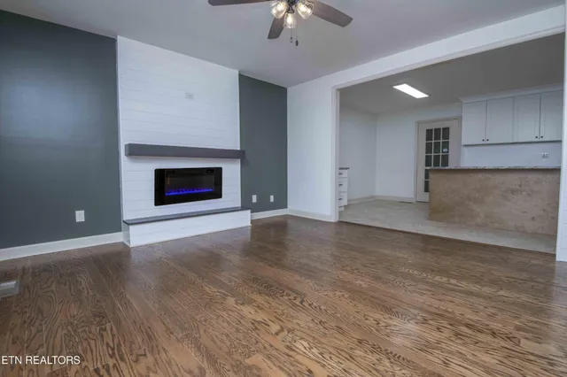 wooden floor fireplace and natural light in room