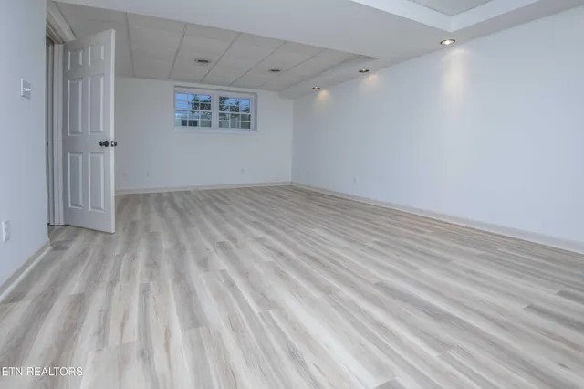 a view of a room with wooden floor