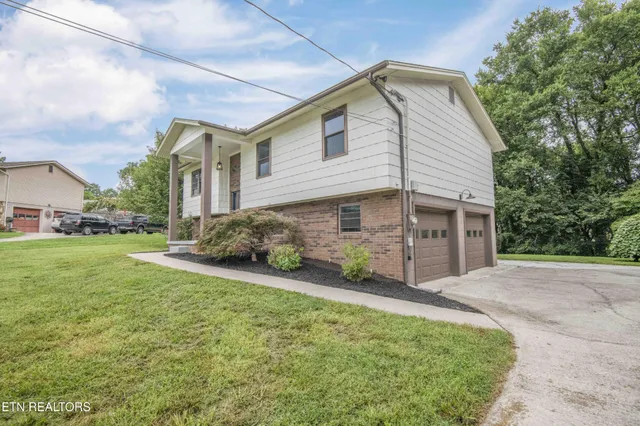 a front view of a house with a yard and garage
