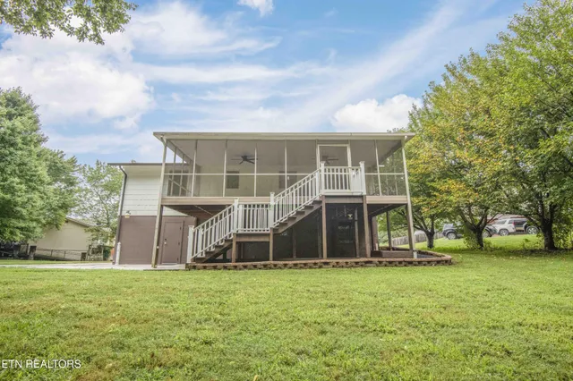 a view of a house with a yard and sitting area