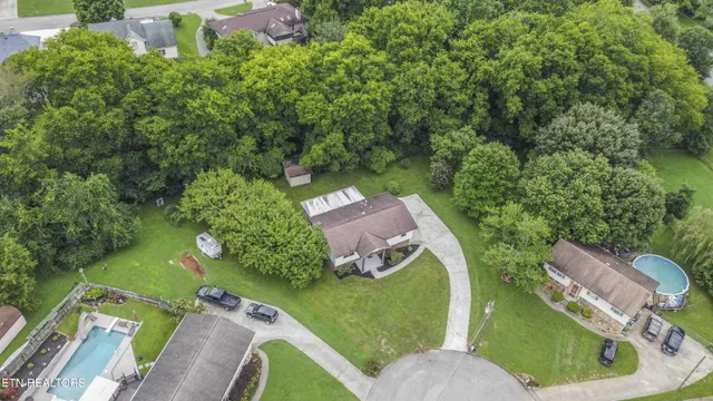 an aerial view of a house with swimming pool a yard and outdoor seating