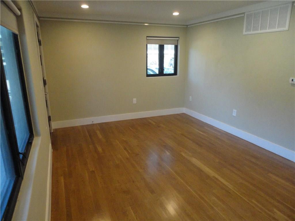 3311 Speedway, Unit D Austin, TX 78705 - Photo 12 of 23 This room features polished wood flooring, a window with a roller blind, and recessed ceiling lights