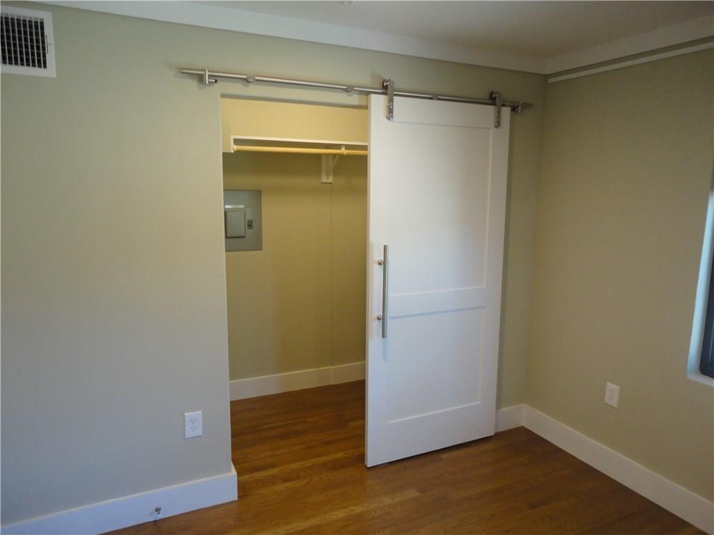 3311 Speedway, Unit D Austin, TX 78705 - Photo 13 of 23 Interior space featuring wood flooring, neutral tone walls, and white trim