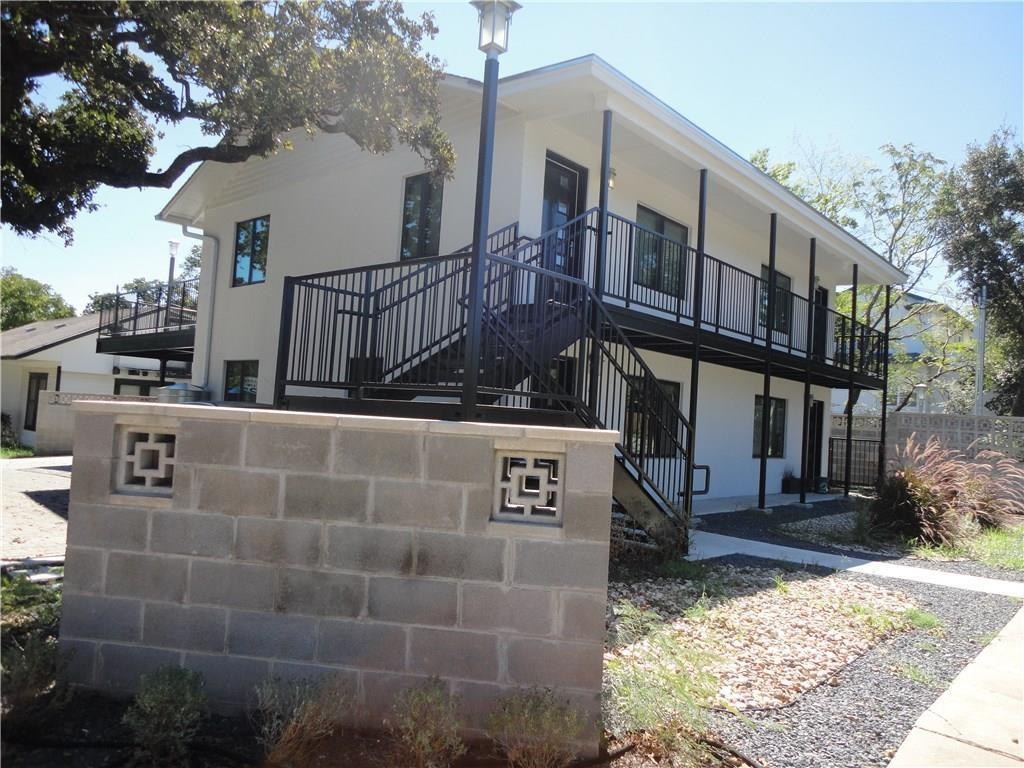 3311 Speedway, Unit D Austin, TX 78705 - Photo 2 of 23 The property features a multi-story exterior with white siding and black railings, offering an inviting aesthetic