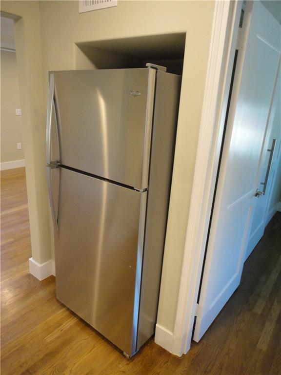 3311 Speedway, Unit D Austin, TX 78705 - Photo 9 of 23 Kitchen featuring a stainless steel refrigerator and hardwood flooring