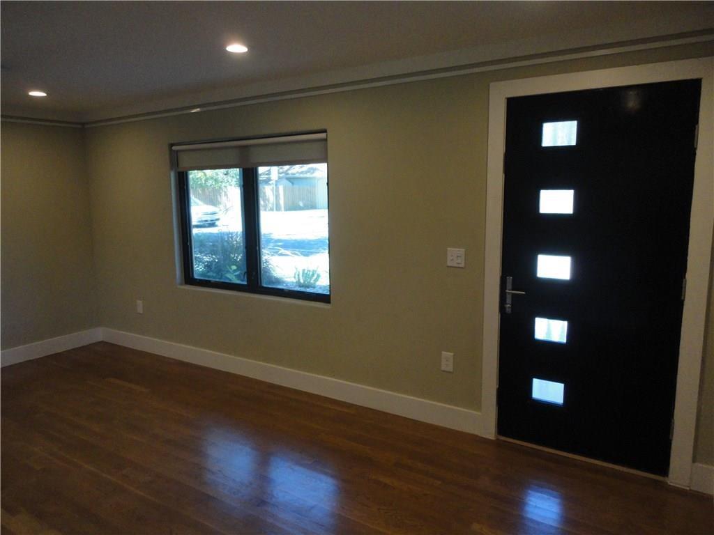 3311 Speedway, Unit D Austin, TX 78705 - Photo 10 of 23 Entryway featuring hardwood floors, a window with a blind, and a dark-colored door with frosted glass panels