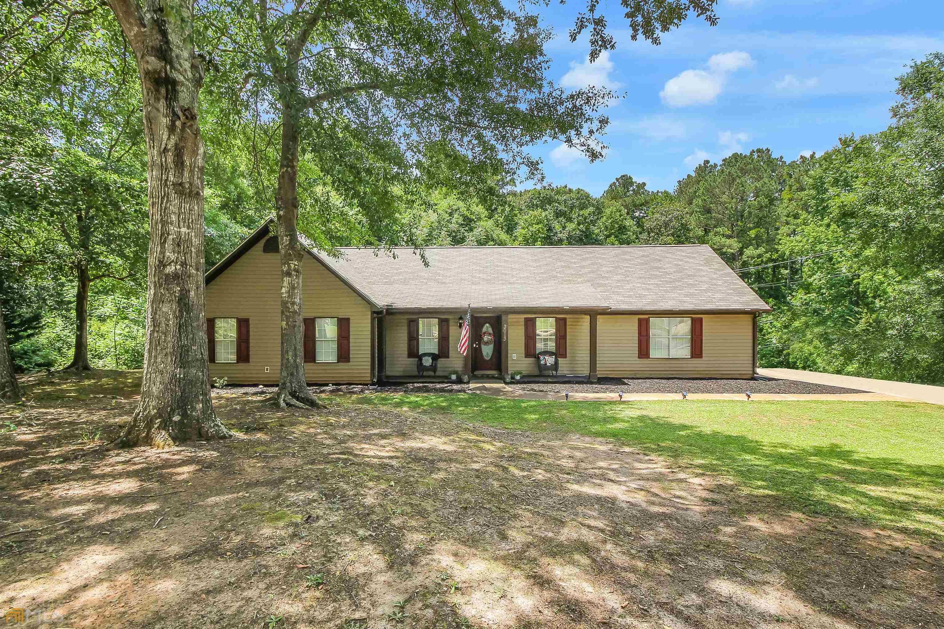 3013 Ryan Road Locust Grove, GA 30248 - Photo 1 of 1 a house with trees in the background