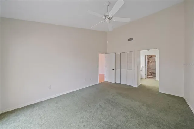 a view of an empty room and a ceiling fan