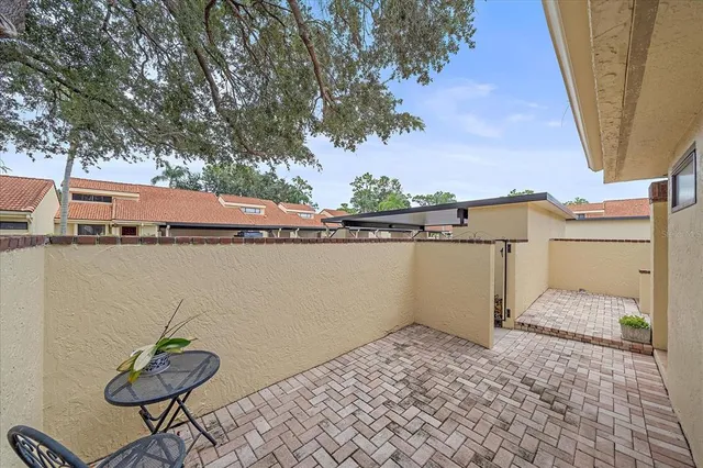 a backyard of a house with table and chair
