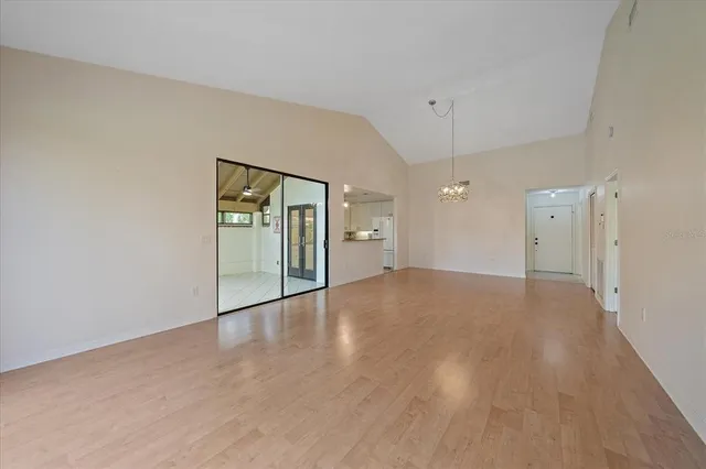 a view of empty room with wooden floor