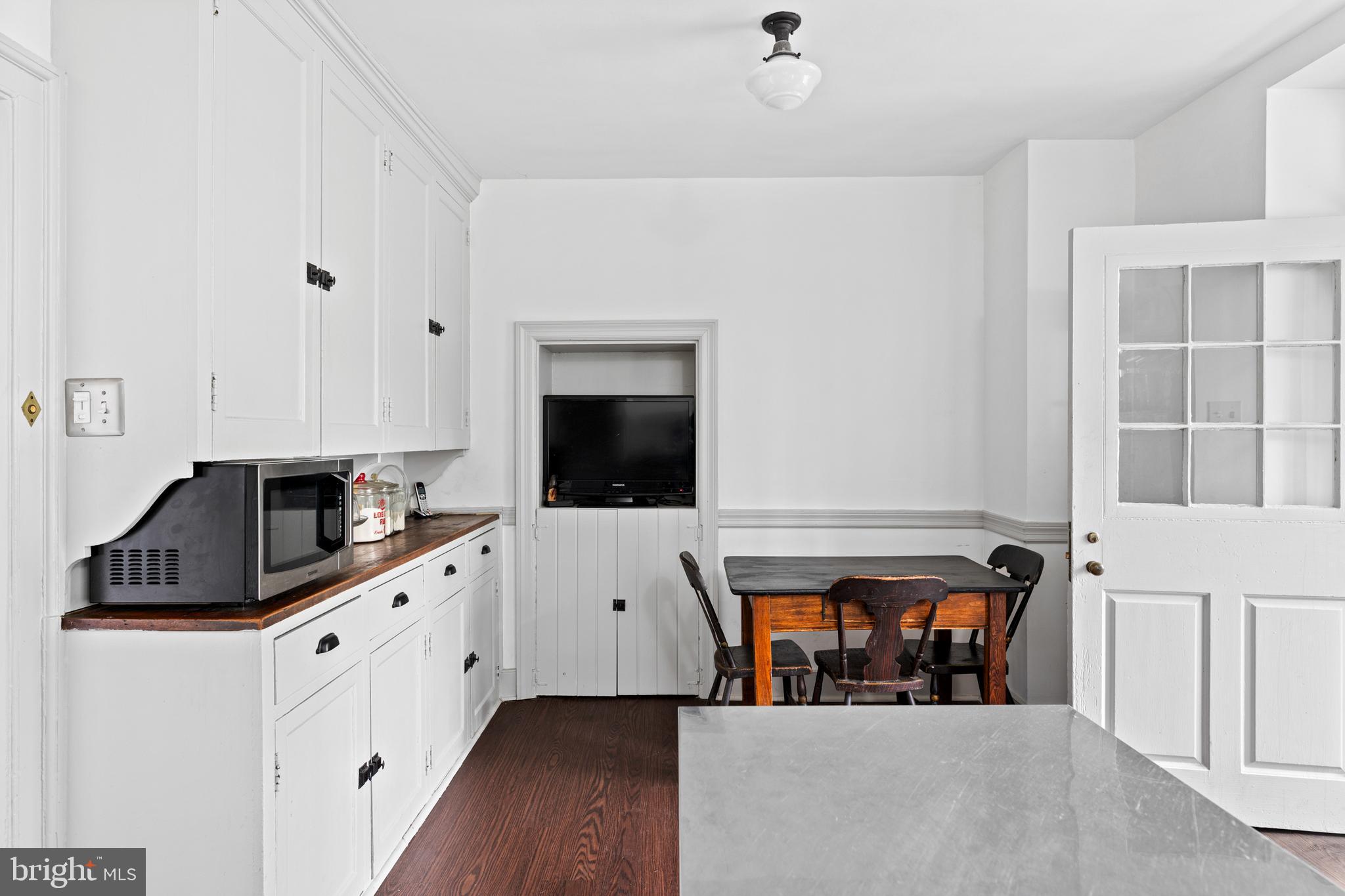 1 East Brookhaven Road Wallingford, PA 19086 - Photo 13 of 57 a living room with stainless steel appliances kitchen island granite countertop a refrigerator and a stove top oven