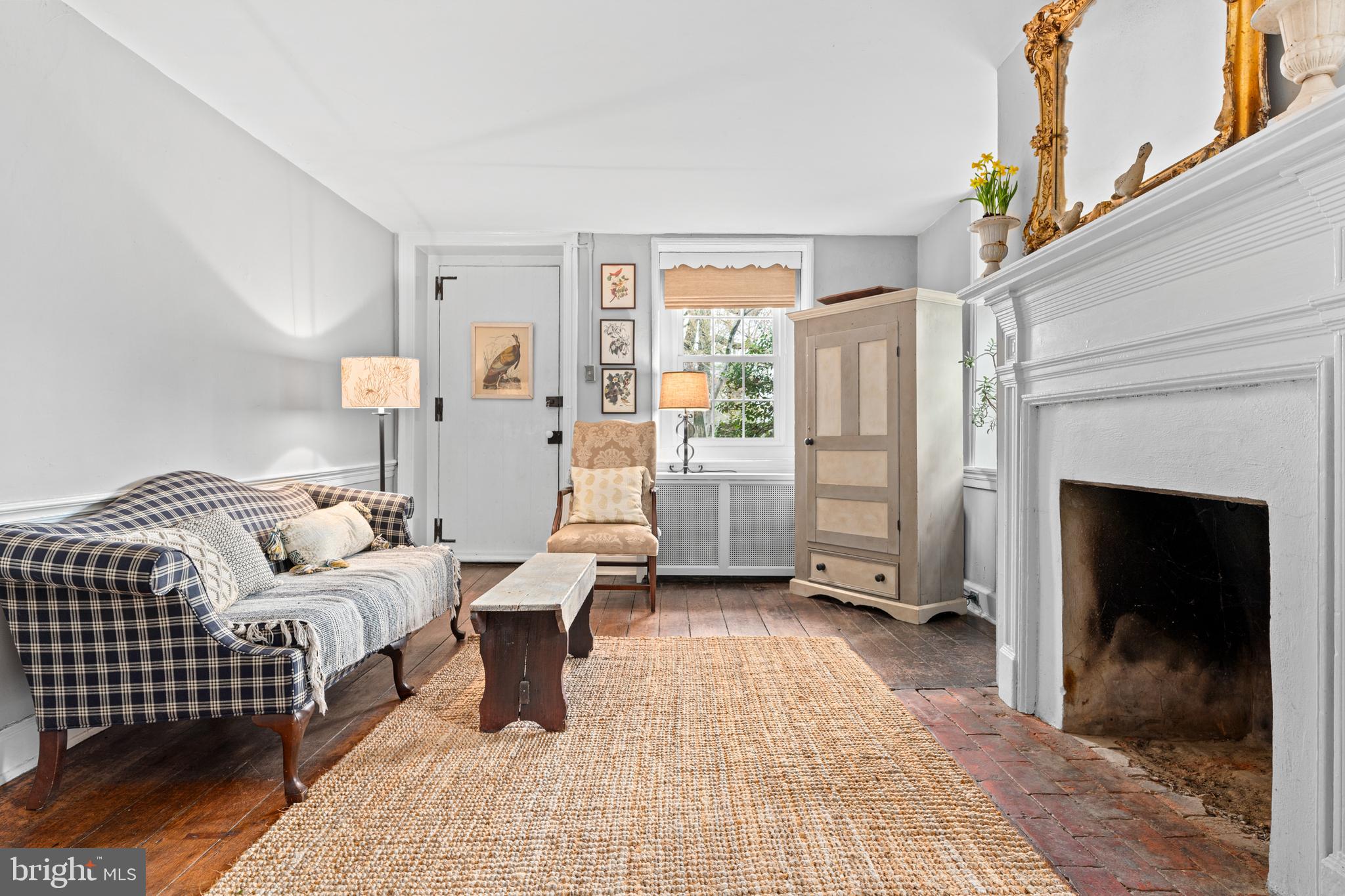 1 East Brookhaven Road Wallingford, PA 19086 - Photo 8 of 57 a room with a bed a mirror and a fireplace