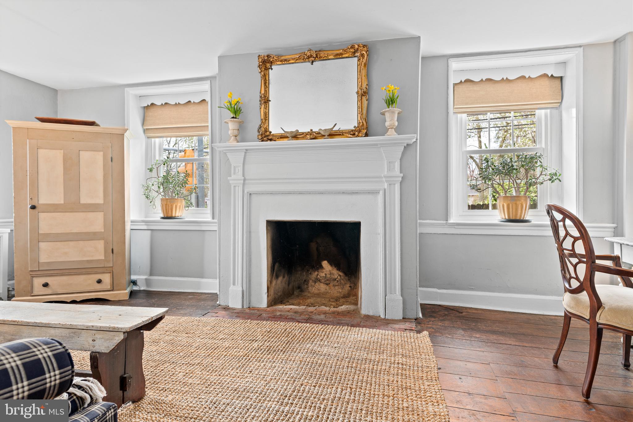 1 East Brookhaven Road Wallingford, PA 19086 - Photo 9 of 57 a living room with furniture a window and a fireplace