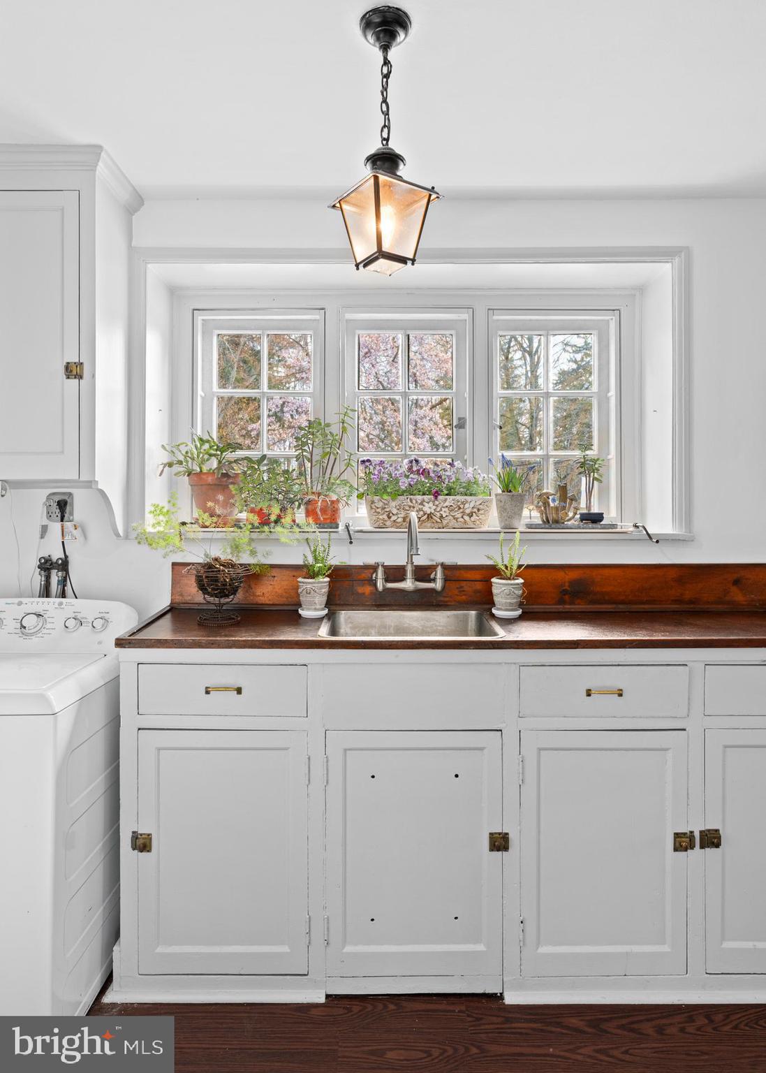 1 East Brookhaven Road Wallingford, PA 19086 - Photo 10 of 57 a kitchen with granite countertop white cabinets and a large window