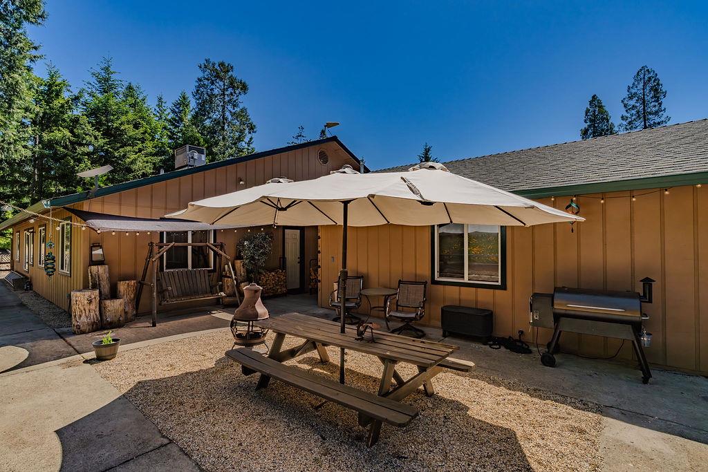26845 Spring Court Pioneer, CA 95666 - Photo 73 of 89 a view of a patio with table and chairs under an umbrella