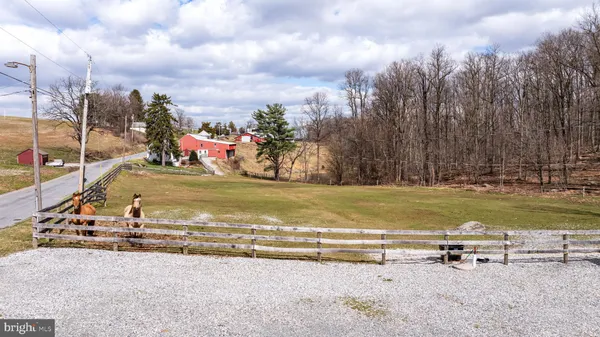 a front view of house with yard and trees in the background