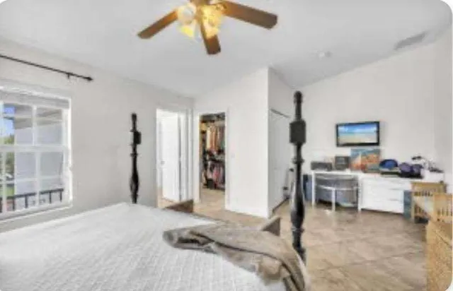 a bedroom with furniture and a window