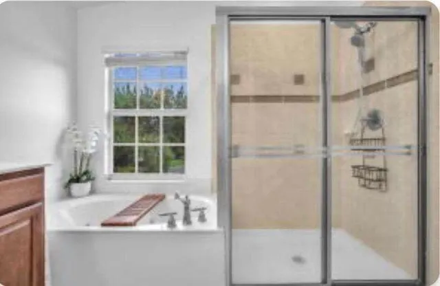 a bathroom with a tub and a shower