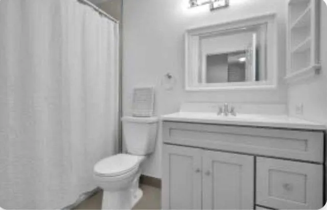 a bathroom with a sink a toilet and mirror