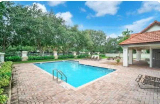 a view of a swimming pool with lounge chair