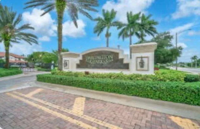 a sign board with palm trees