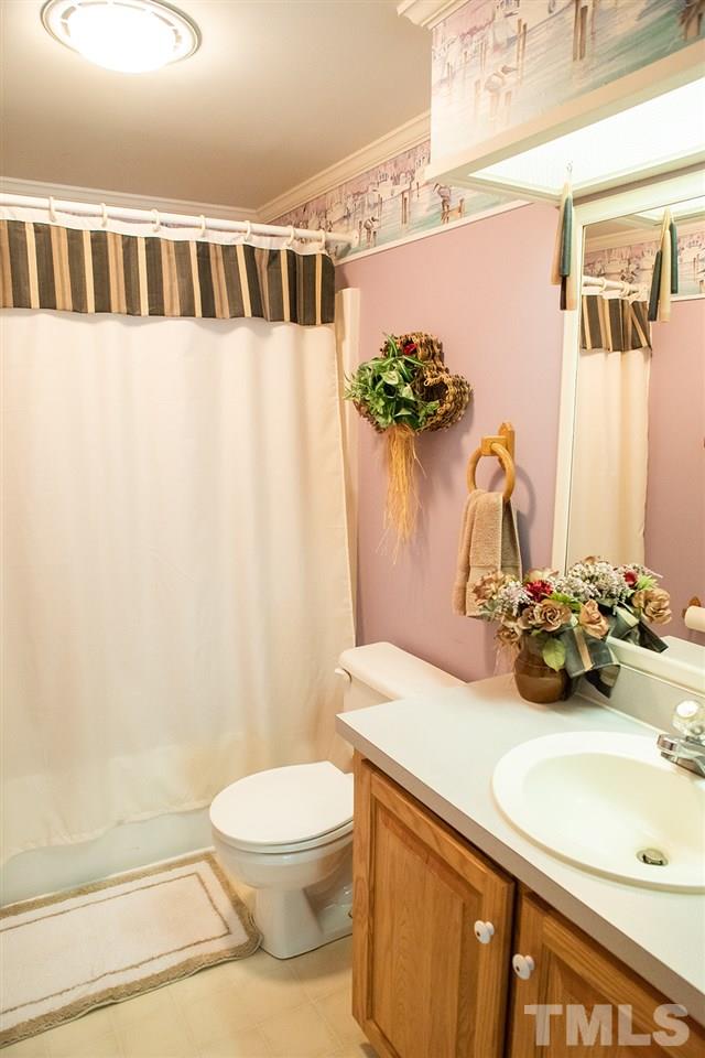 1579 Julian Oakley Road Rougemont, NC 27572 - Photo 11 of 15 a bathroom with a sink a toilet and shower