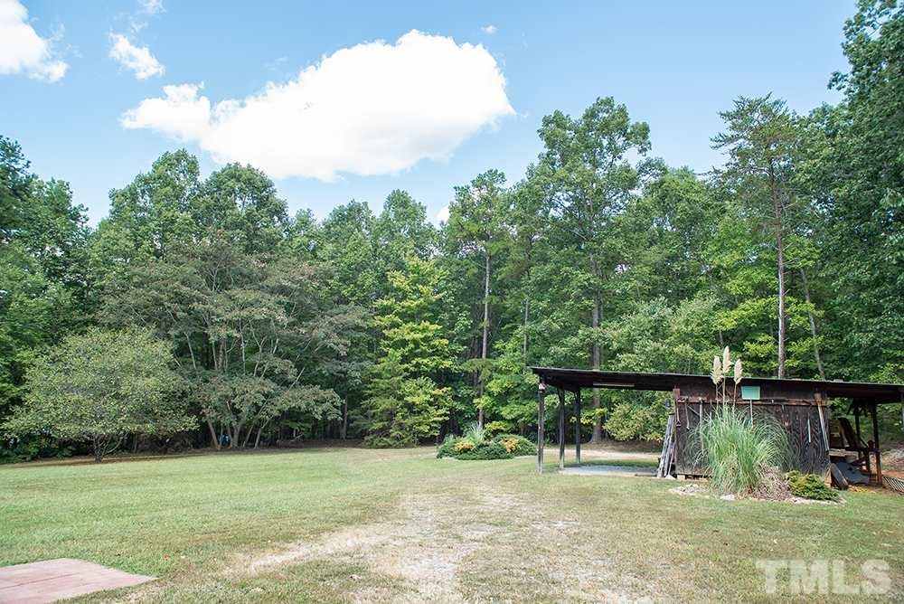 1579 Julian Oakley Road Rougemont, NC 27572 - Photo 12 of 15 a backyard of a house with lots of green space