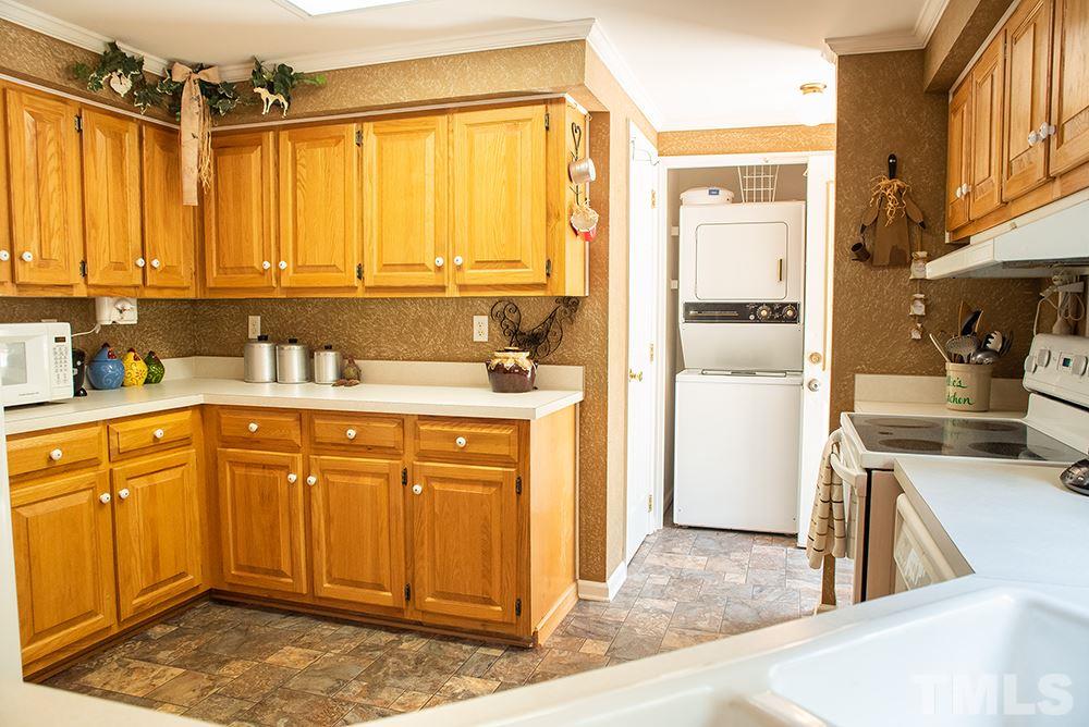 1579 Julian Oakley Road Rougemont, NC 27572 - Photo 5 of 15 a kitchen with a refrigerator a sink and cabinets