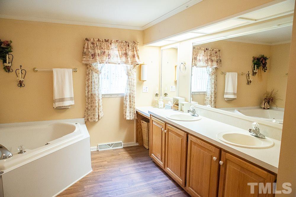 1579 Julian Oakley Road Rougemont, NC 27572 - Photo 8 of 15 a bathroom with a tub sink and mirror