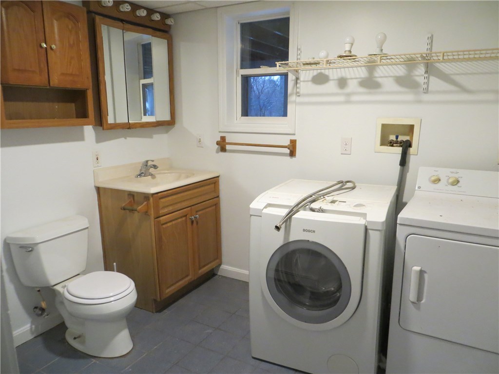 83 Columbia Heights Road Charlestown, RI 02813 - Photo 15 of 26 Full bathroom with laundry in basement.