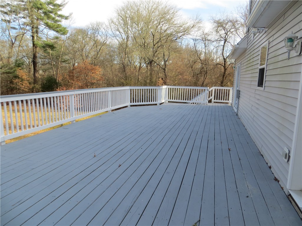 83 Columbia Heights Road Charlestown, RI 02813 - Photo 17 of 26 Large deck off kitchen as well as sliders from master bedroom.