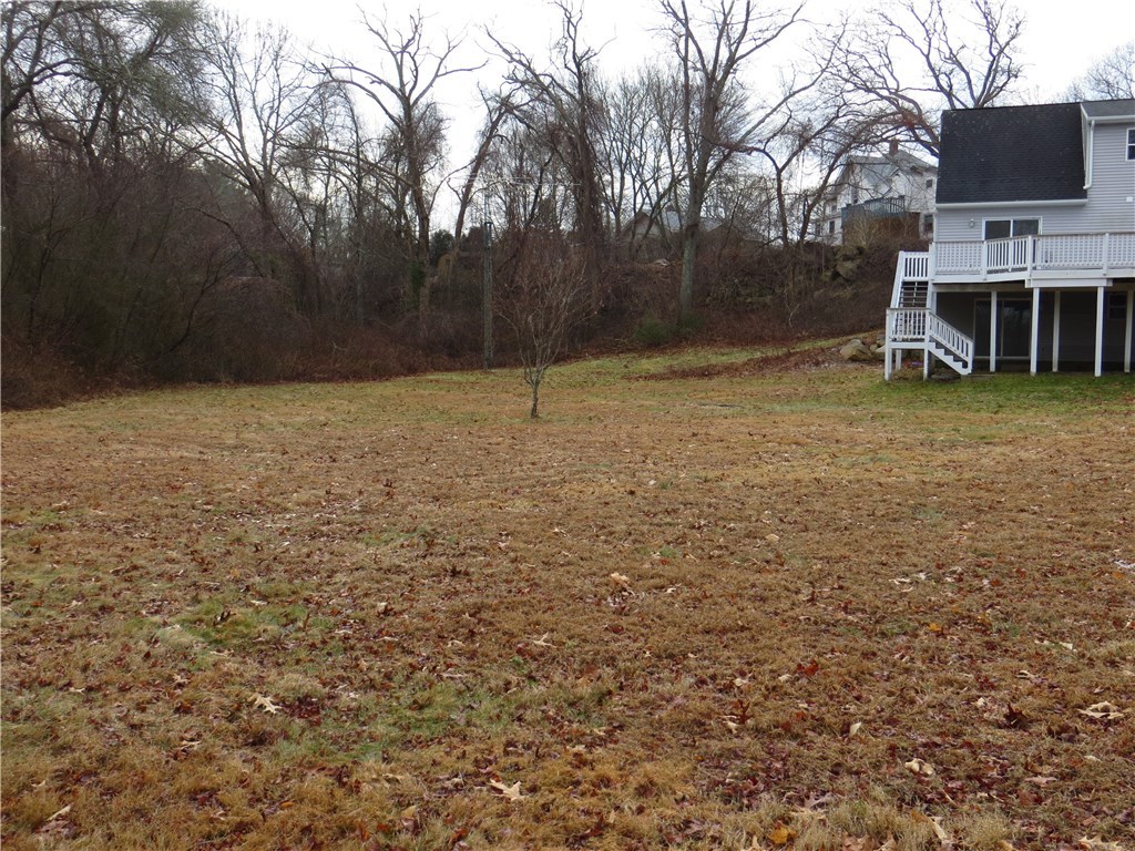 83 Columbia Heights Road Charlestown, RI 02813 - Photo 21 of 26 Looking towards side yard from back yard. All open plenty of room to put in gardens, play games.
