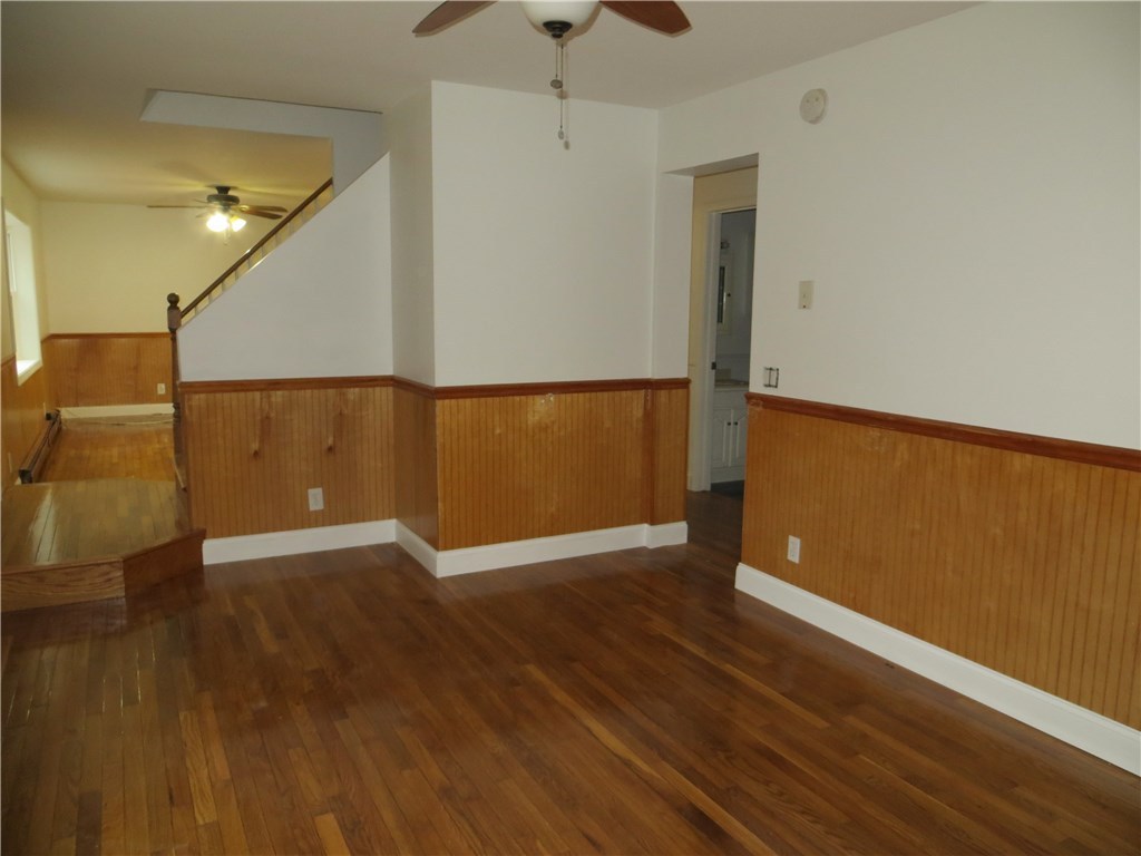 83 Columbia Heights Road Charlestown, RI 02813 - Photo 6 of 26 Living room into dining room as well as hallway and bath.