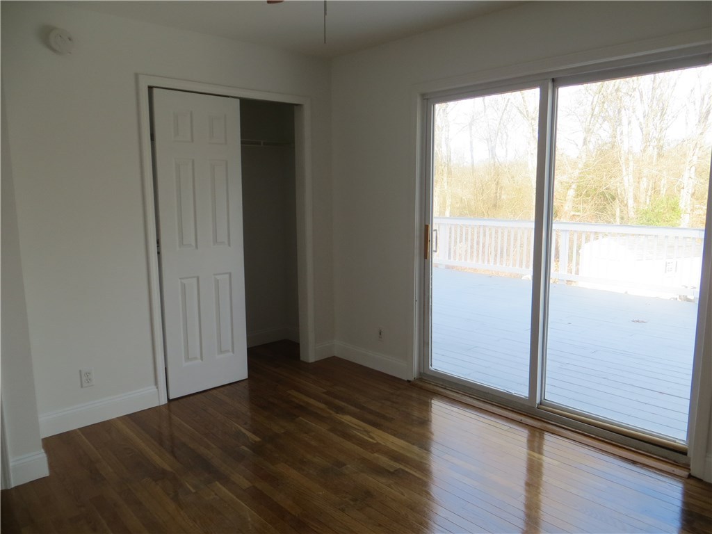 83 Columbia Heights Road Charlestown, RI 02813 - Photo 7 of 26 Master bedroom on first floor. Slider opens to deck.
